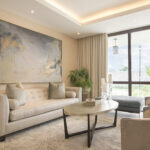 Image of the living area with couch, table and chair in this condo in The Colonial in Santa Maria