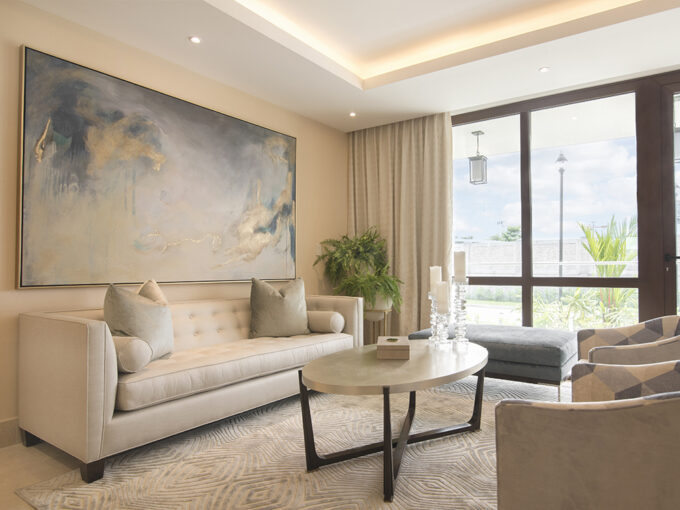 Image of the living area with couch, table and chair in this condo in The Colonial in Santa Maria