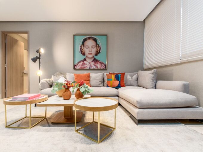 Image of living area with couch, table and chairs and paintings at Deluxe