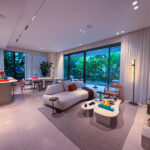 Image of living area with balcony, couch, and table in this condo for sale in Bioma