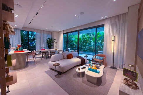 Image of living area with balcony, couch, and table in this condo for sale in Bioma