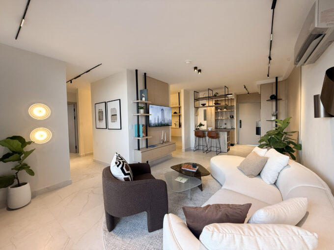 Image of the living area with a couch and chair in this condo for sale in Next in Coco del Mar