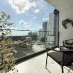 Image of balcony with city views and two chairs in this condo for sale in NEXT in Coco del Mar