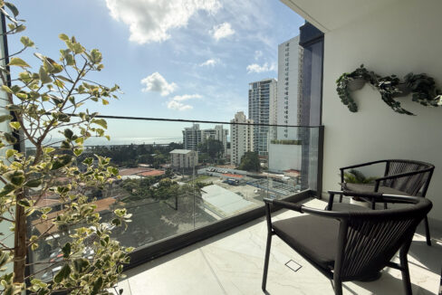 Image of balcony with city views and two chairs in this condo for sale in NEXT in Coco del Mar