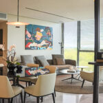 Image of living room with couch, table and chairs in this condo for sale in The Ivy