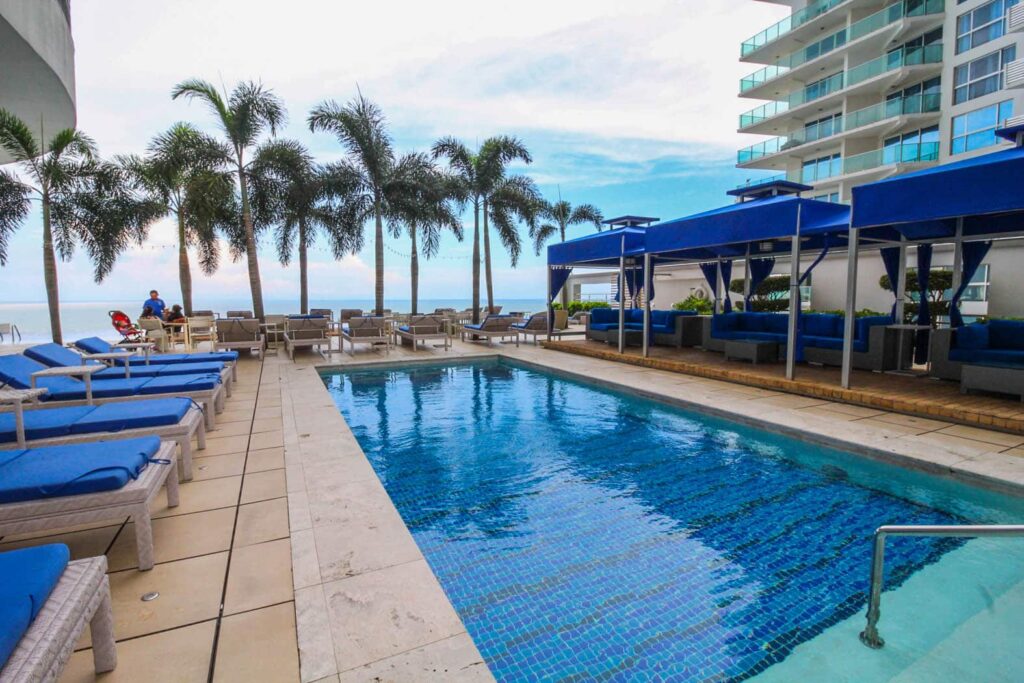 Image of swimming pool with deck chairs in this condo for sale in the JW Marriott
