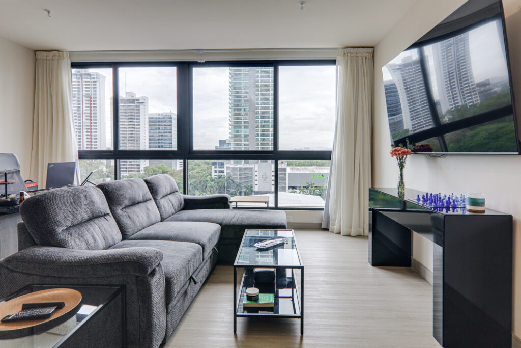 Image of the living area with a couch, table and television at Arcadia