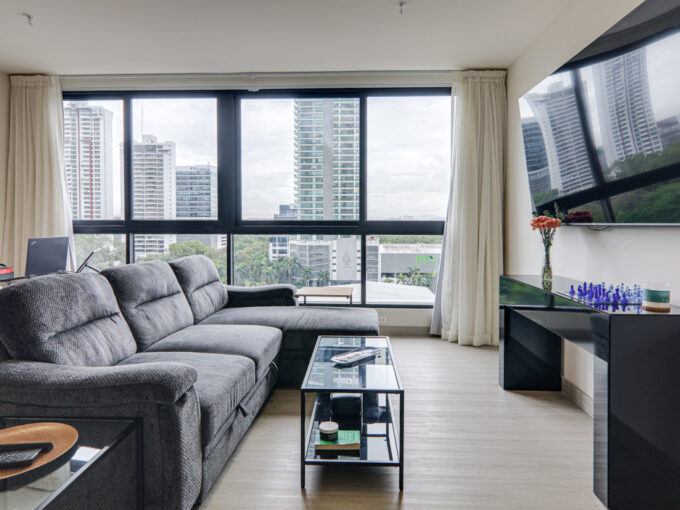 Image of the living area with a couch, table and television at Arcadia