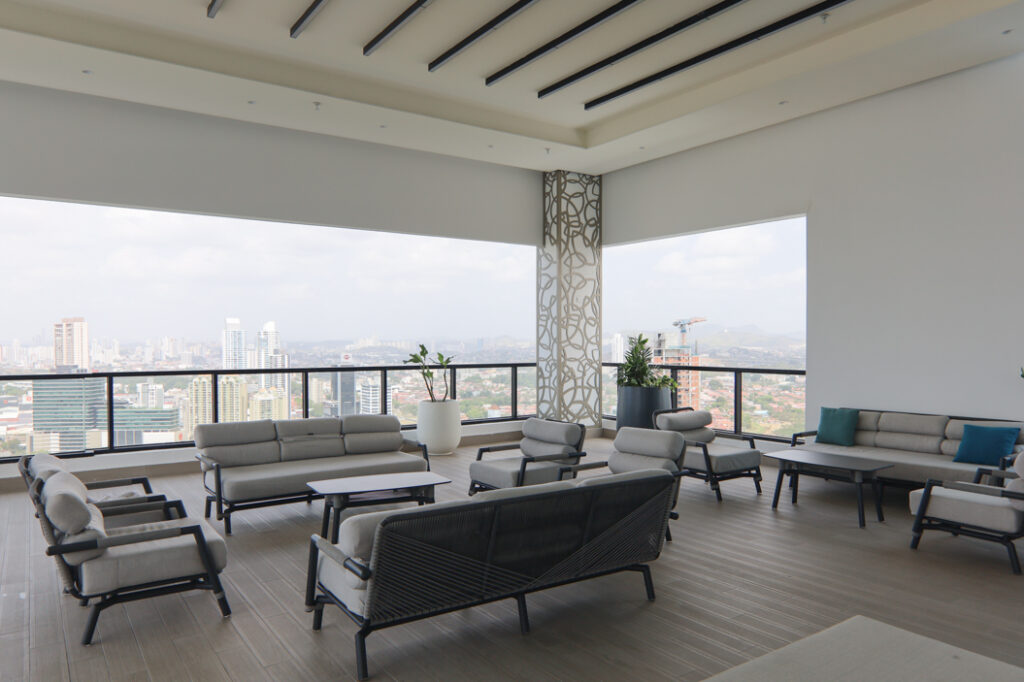 Image of a balcony, table, and couches at Arcadia