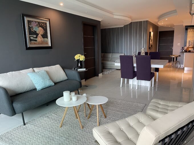 Image of living area with couch and chairs in this condo for sale in Allure