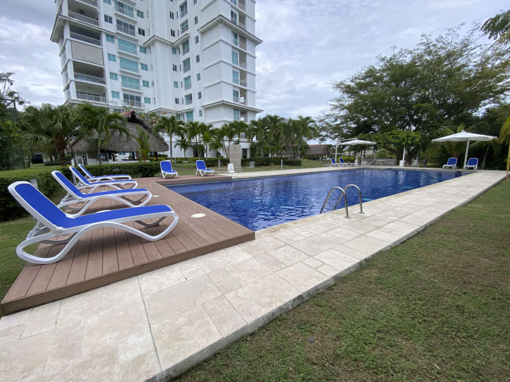 Image of swimming pool with deck chairs at Cocoli