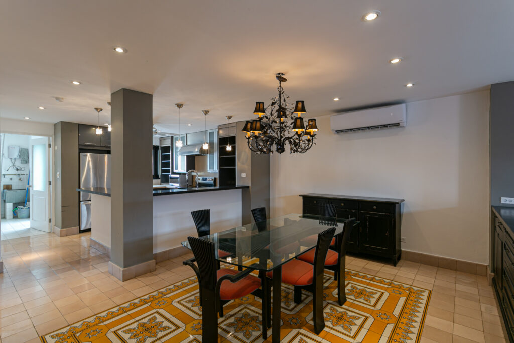 Image of living area with a dining table and chairs and partial view of the kitchen at Cuatro Casas