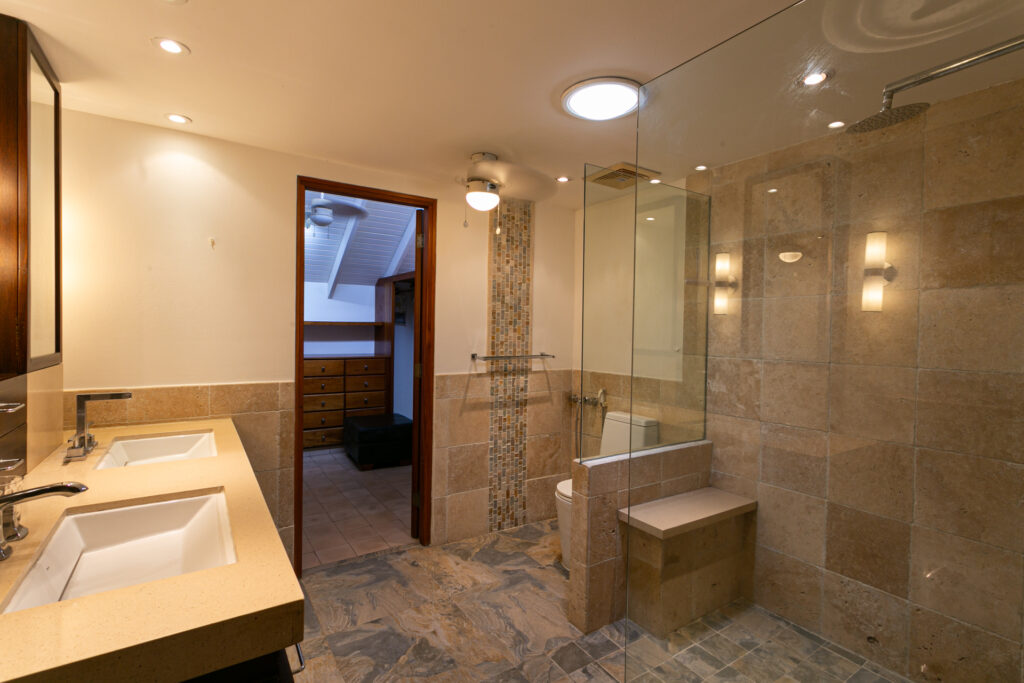 Image of bathroom with double sinks, and shower at Cuatro Casas