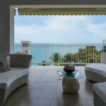 Image of terrace with chair, table and ocean view at Bijao