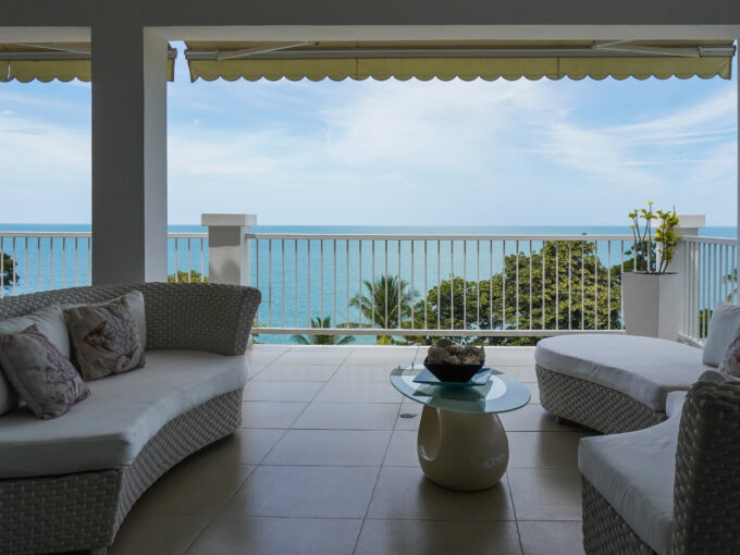 Image of terrace with chair, table and ocean view at Bijao