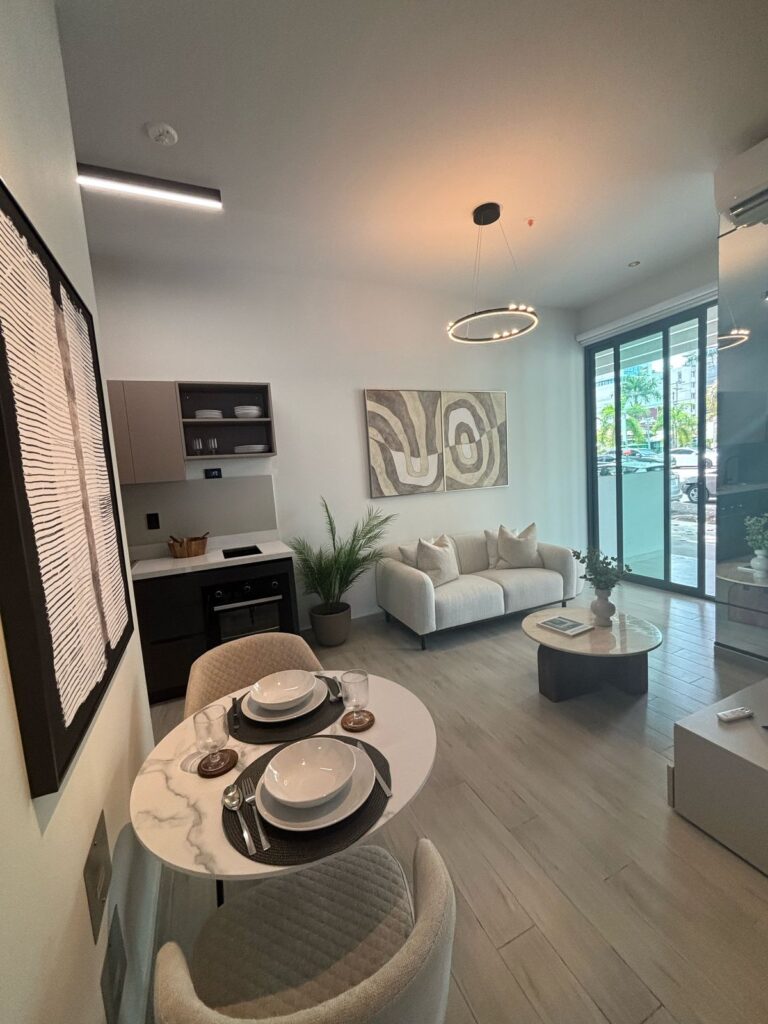 Image of the living area with a couch, window and furnishings at Alexa Tower