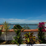 Image of terrace with ocean view in this condo for sale in Cuatro Casas