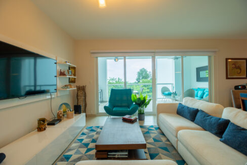 Image of living room with table, couch, chair, table and television in this condo in Sherman Tower 1 in Bijao