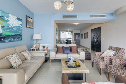 Image of the living room with two couches, a coffee table and two chairs in this condo in San Francisco Bay