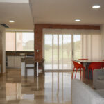 Image of the living area with television, table and two chairs in this condo in Vista Mar