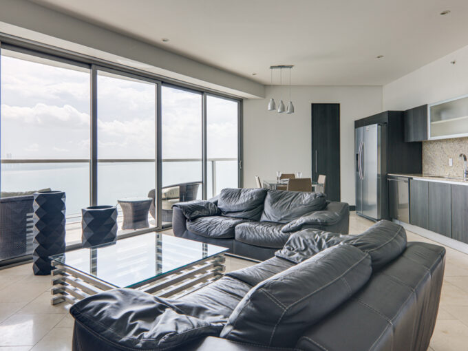 Image of living area with table and two couches in this condo in TOC in Punta Pacifica