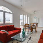 Image of Living and Dining room with sofa and tables in this condo in Tucan Country Club
