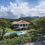 Image of house with trees ,pool and mountain in Playa Malibu Gorgona