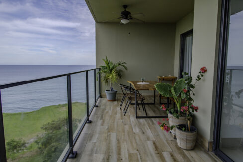 Image of balcony with ocean views, a table and chairs and plants in this condo in Solaria, Punta Caelo