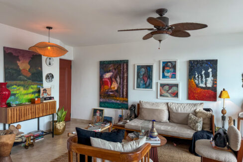 Image of the living area with a balcony, chair, couch and table in this condo in Marquis Tower in El Cangrejo
