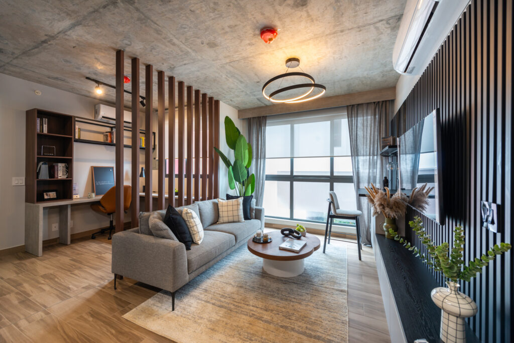 Image of living area with couch, table and television in this condo in Centriqo in Panama Pacifico