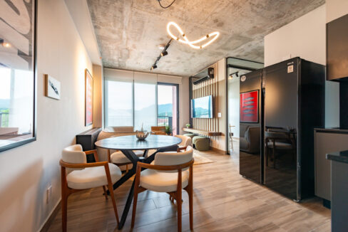 Image of refrigerator, couches and windows in this condo in Centriqo