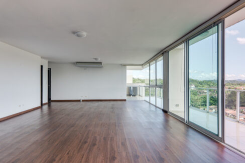 Image of living room with large windows in this penthouse in Pine Hill