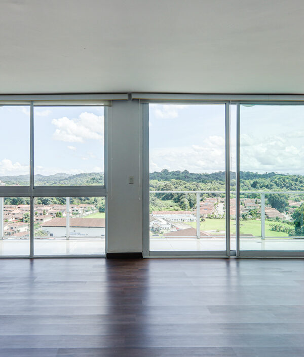 Image of living area with large windows and views from this penthouse in Pine Hill