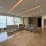 Living room with floor to ceiling windows and couch in Q Tower