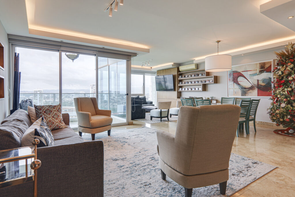 Image of living area with windows, couch and chairs in this condo in Titanium