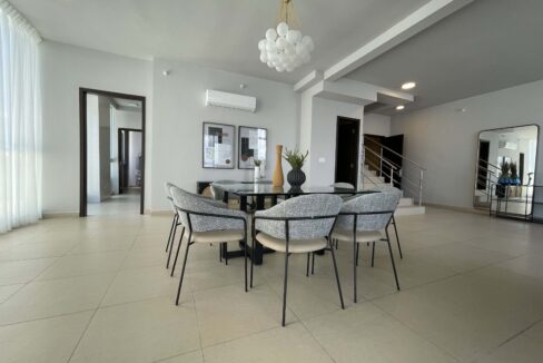 Image of living area with table and chairs in this condo in Country Club