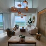 Image of living space with couch, two chairs, and balcony in this loft in Ocean Waves, Gorgona