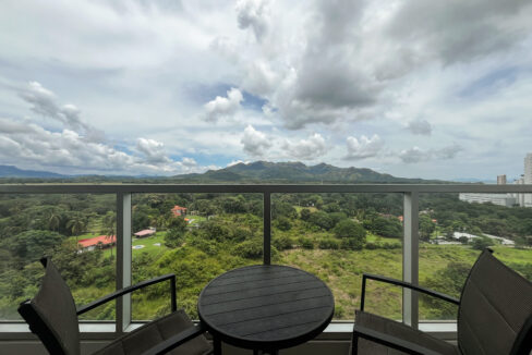 Image of balcony with a small table and two chairs in this condo in Royal Palm