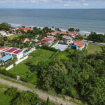 Image of this Costa Esmeralda lot for sale with views of the ocean and surrounding homes