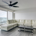 Image of living area with couch and table in this ocean view condo in Terrawind