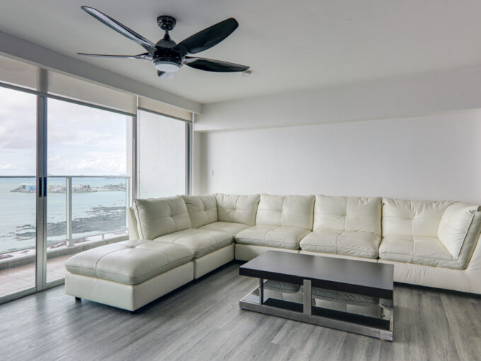 Image of living area with couch and table in this ocean view condo in Terrawind