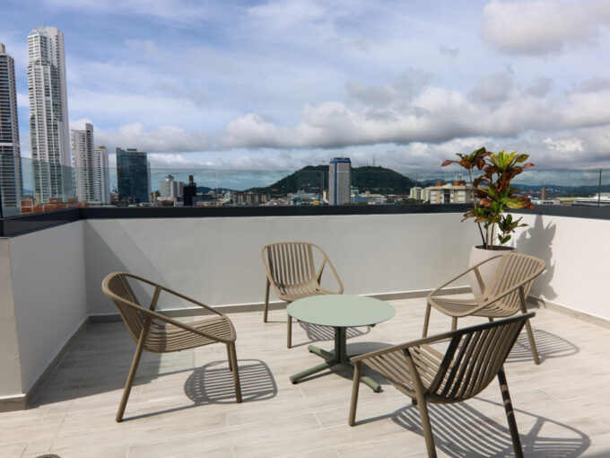 Image of rooftop terrace with table and chairs in this condo in Alexa