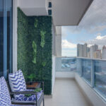 Image of balcony with two chairs and city views in this Remodeled Condo for Sale
