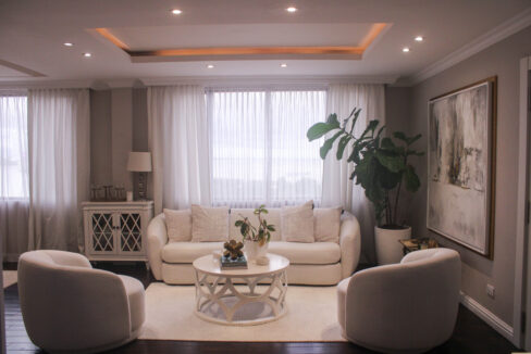 Image of living area with table, couch, and two chairs in this condo for sale in Belvedere Park