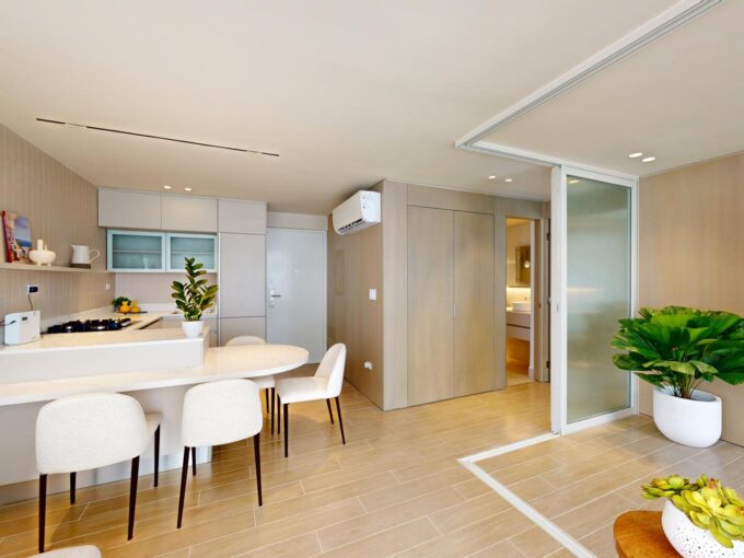 Image of main living area with views of kitchen in this Armonia condo for sale