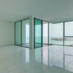 Image of the living area with ocean views in this condo for sale in Pacific Point 400