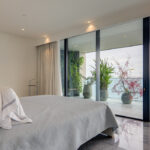 Image of bedroom with ocean view and bed in this condo for sale in Upper East