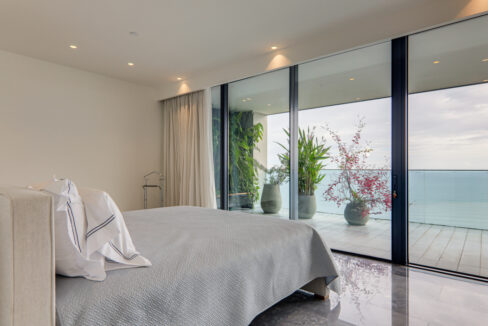 Image of bedroom with ocean view and bed in this condo for sale in Upper East