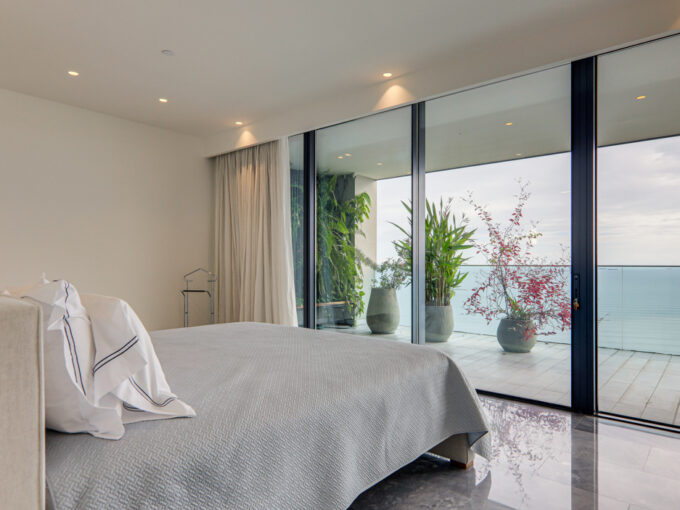 Image of bedroom with ocean view and bed in this condo for sale in Upper East