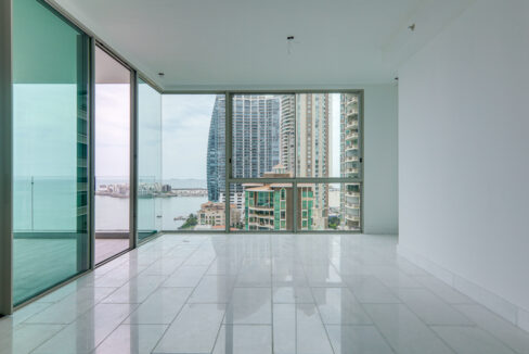 Image of living room with windows with views of th city and skyline in this condo for sale in Pacific Point